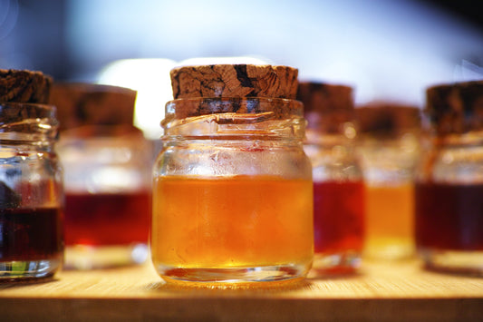 jars of different kinds of honey closed by a cork