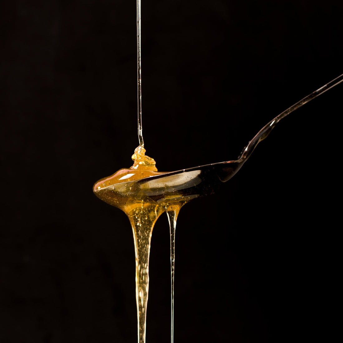 spoon full of honey dripping.