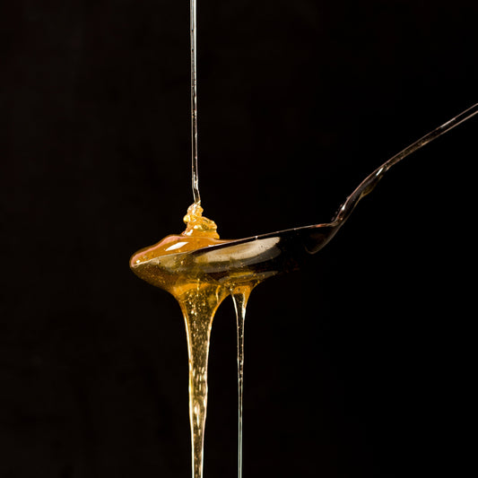 spoon full of honey dripping.